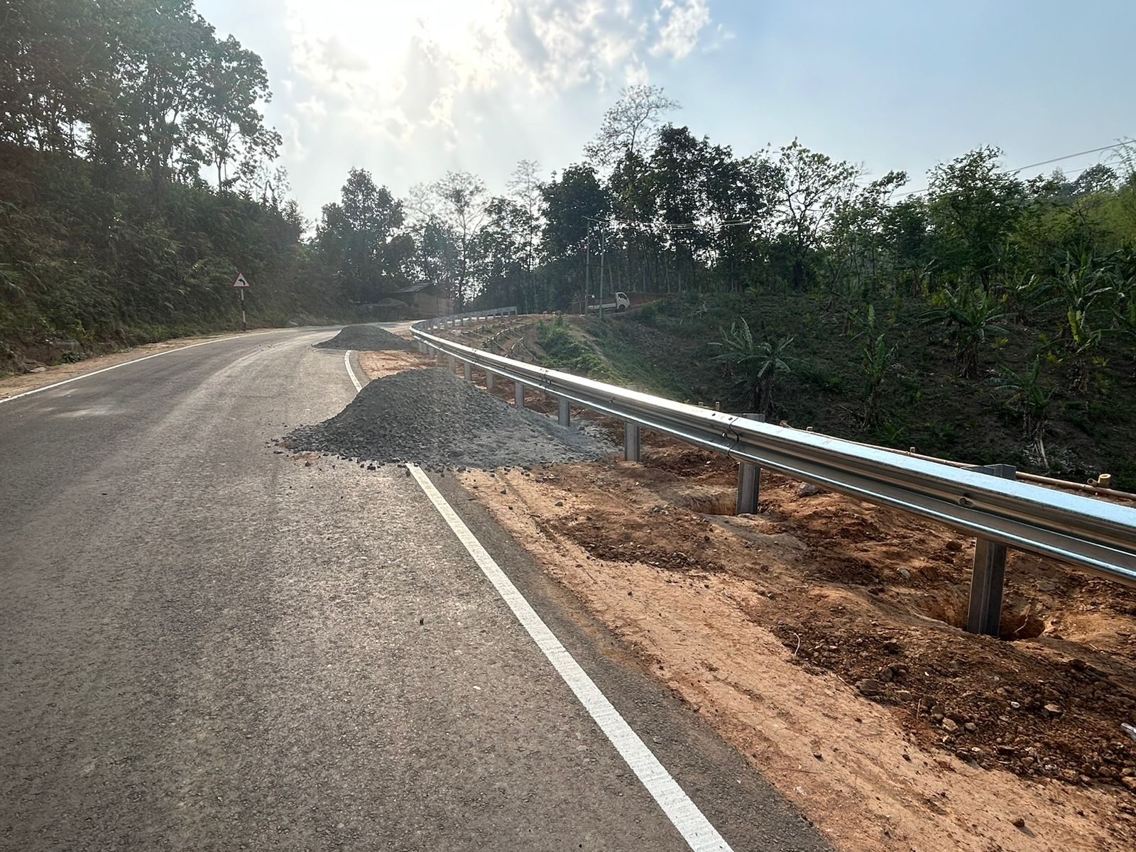 W beam crash barrier installed along a hillside road at Mendipathar